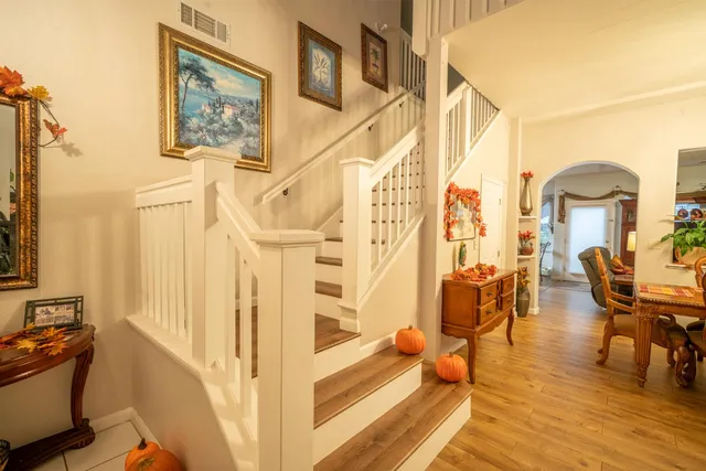 a view of a living room and dining room with wooden floor