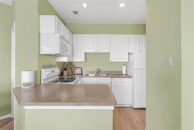 a kitchen with a sink a stove and cabinets