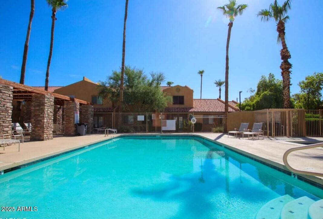 3511 East Baseline Road, Unit 1049 Phoenix, AZ 85042 - Photo 2 of 10 a view of a house with swimming pool