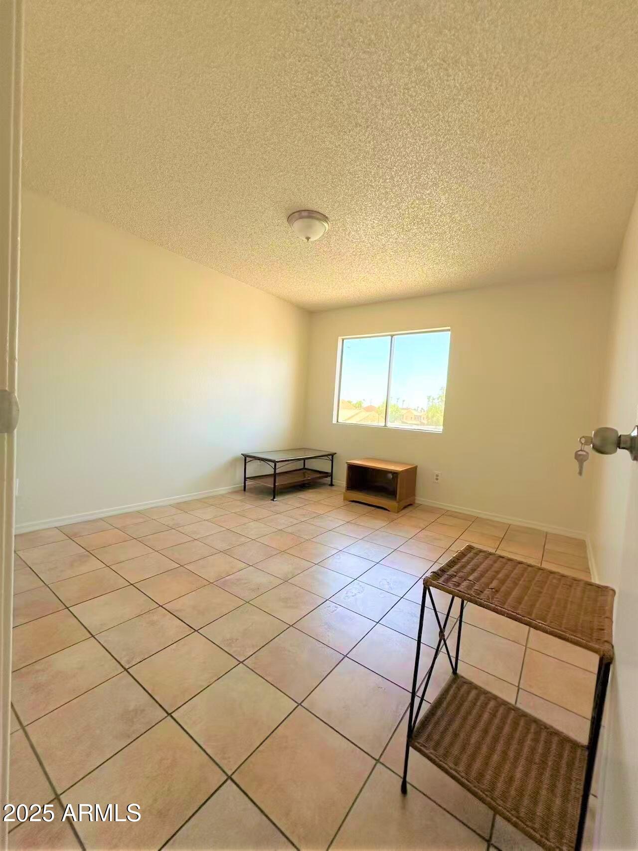 3511 East Baseline Road, Unit 1049 Phoenix, AZ 85042 - Photo 6 of 10 a bedroom with a bed and window