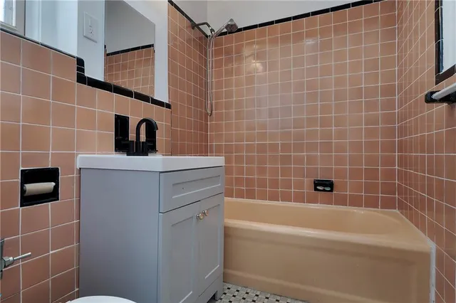 a bathroom with a bathtub and a shower