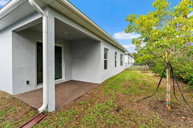 an aerial view of residential houses with outdoor space and lake view