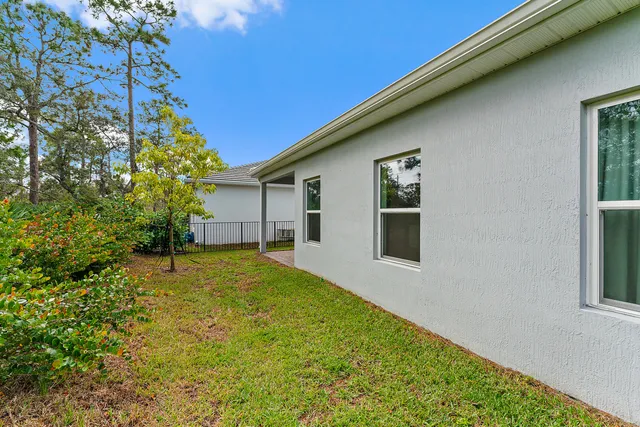 an aerial view of residential houses with outdoor space and a lake view