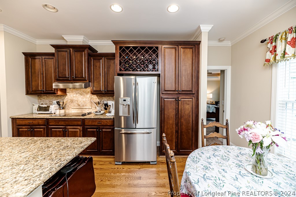 78 Spring Pond Lane Spring Lake, NC 28390 - Photo 17 of 46 a kitchen with granite countertop a refrigerator and a stove top oven
