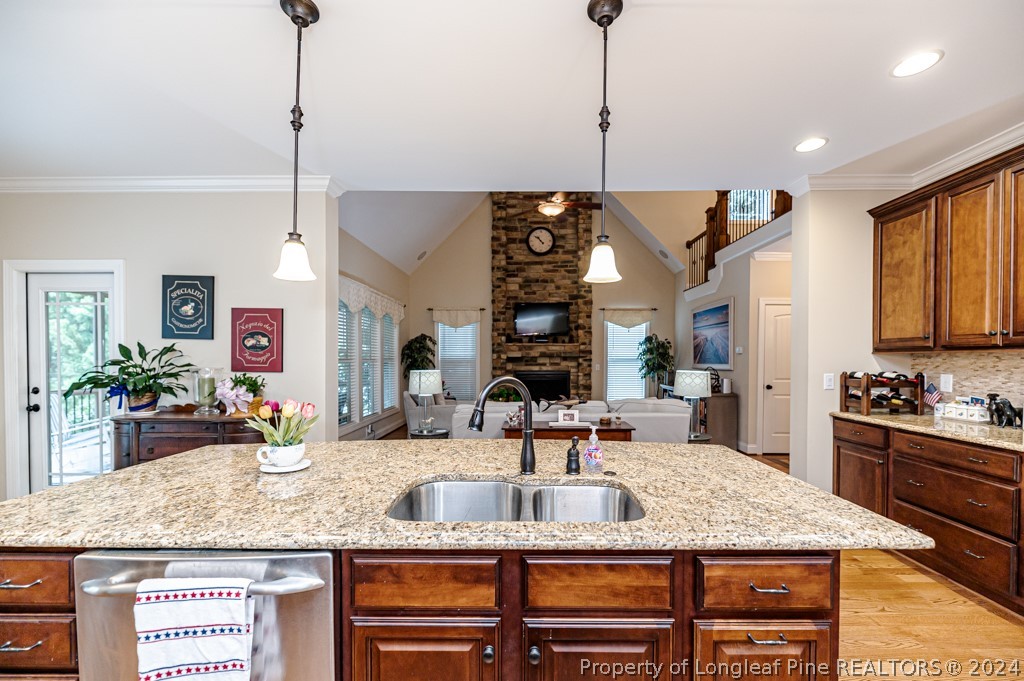 78 Spring Pond Lane Spring Lake, NC 28390 - Photo 20 of 46 a kitchen with a stove a sink and a wooden floor