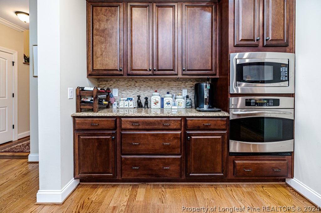 78 Spring Pond Lane Spring Lake, NC 28390 - Photo 21 of 46 a kitchen with stainless steel appliances granite countertop wooden cabinets and a stove top oven