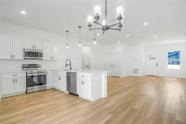 a kitchen with stainless steel appliances a refrigerator sink and stove