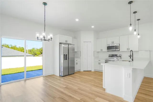 a big room with wooden floor and bathroom