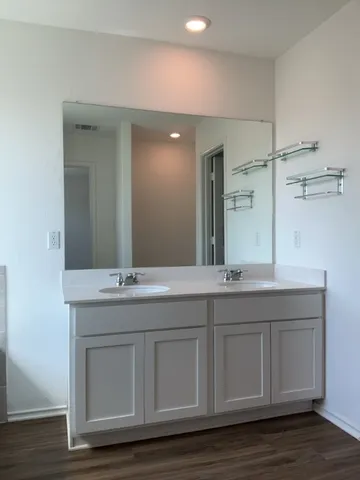 a bathroom with a double vanity sink and mirror