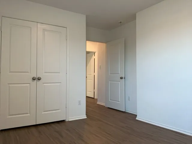 a view of an empty room and wooden floor