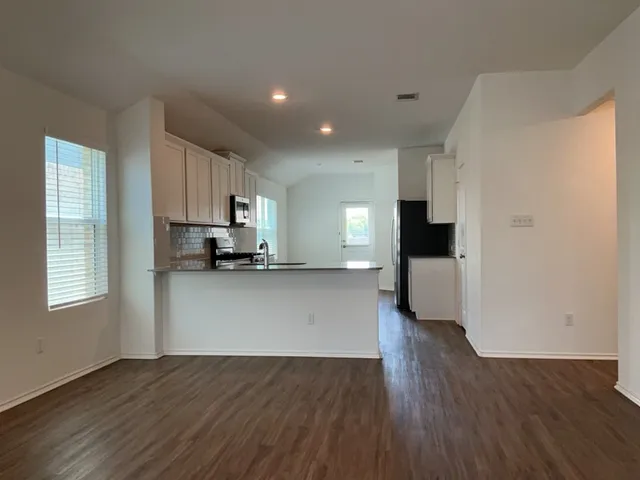 a view of kitchen with cabinets and wooden floor