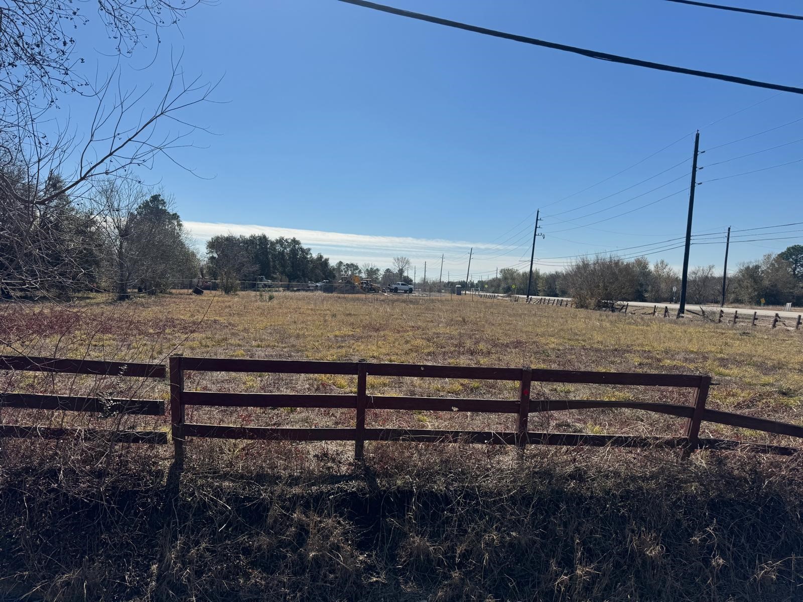 a view of a yard with wooden fence