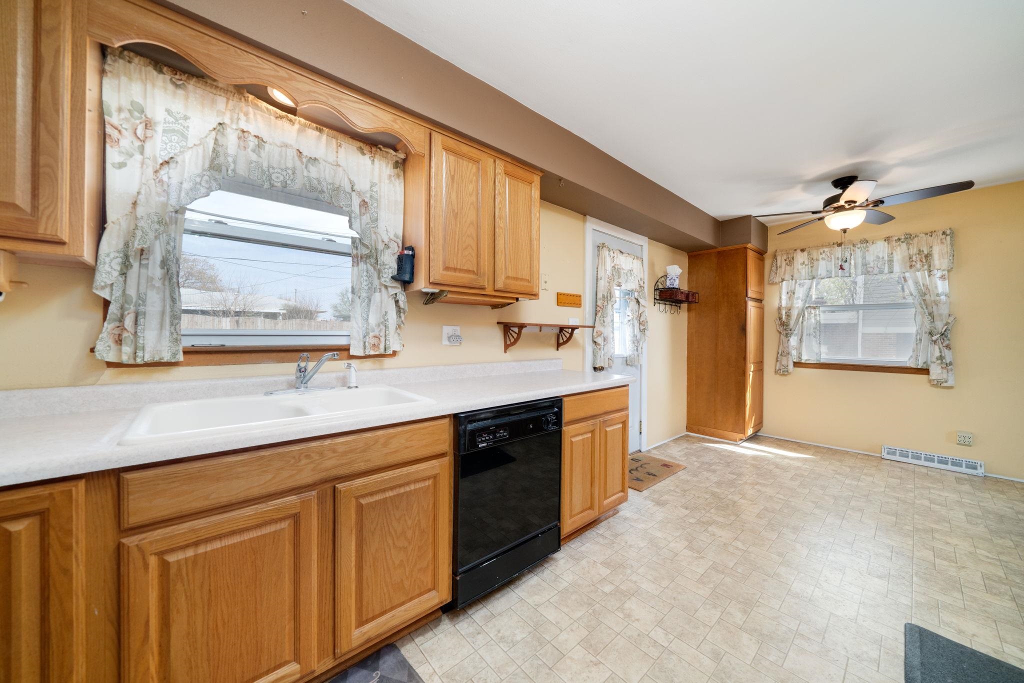 1611 Notre Dame Road Rockford, IL 61103 - Photo 10 of 33 a large kitchen with kitchen island granite countertop a sink window and cabinets