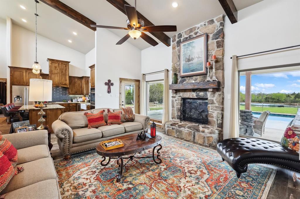 812 McKenzie Road Collinsville, TX 76233 - Photo 11 of 40 a living room with patio fireplace furniture and a floor to ceiling window