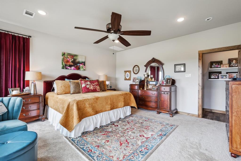 812 McKenzie Road Collinsville, TX 76233 - Photo 13 of 40 a bedroom with a bed and ceiling fan