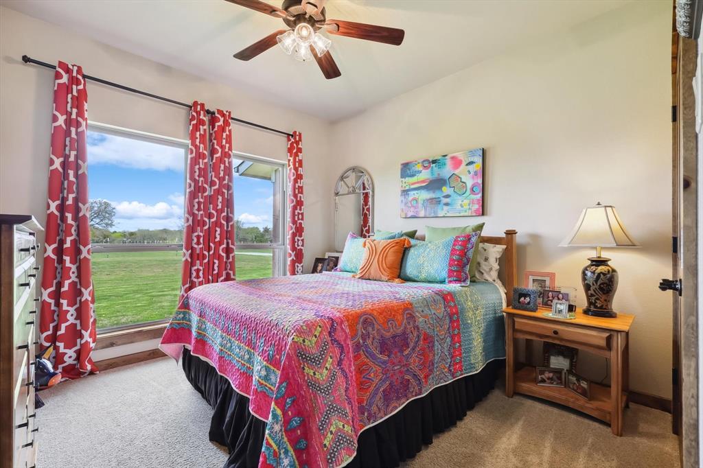 812 McKenzie Road Collinsville, TX 76233 - Photo 16 of 40 a bedroom with a bed and a chandelier