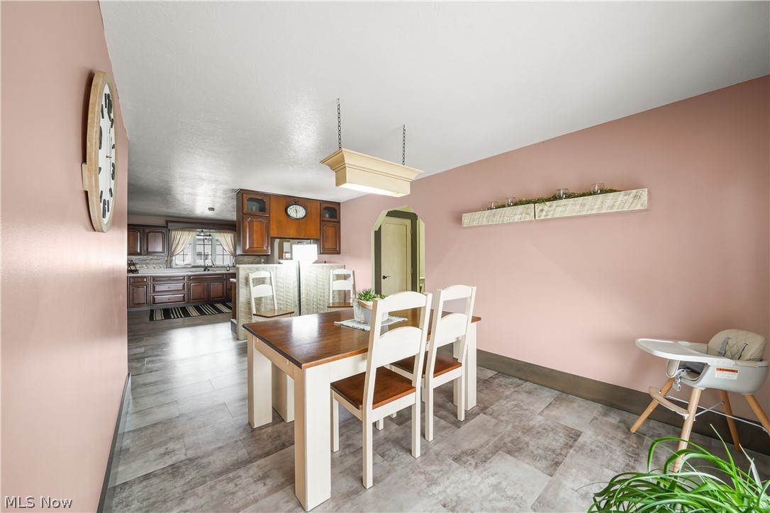9561 Creaser Road North Bloomfield, OH 44450 - Photo 6 of 45 Dining space featuring arched walkways and baseboards