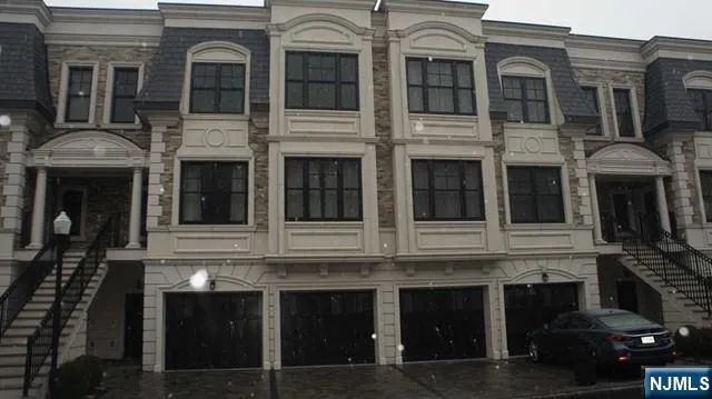 a front view of a building with a lot of windows