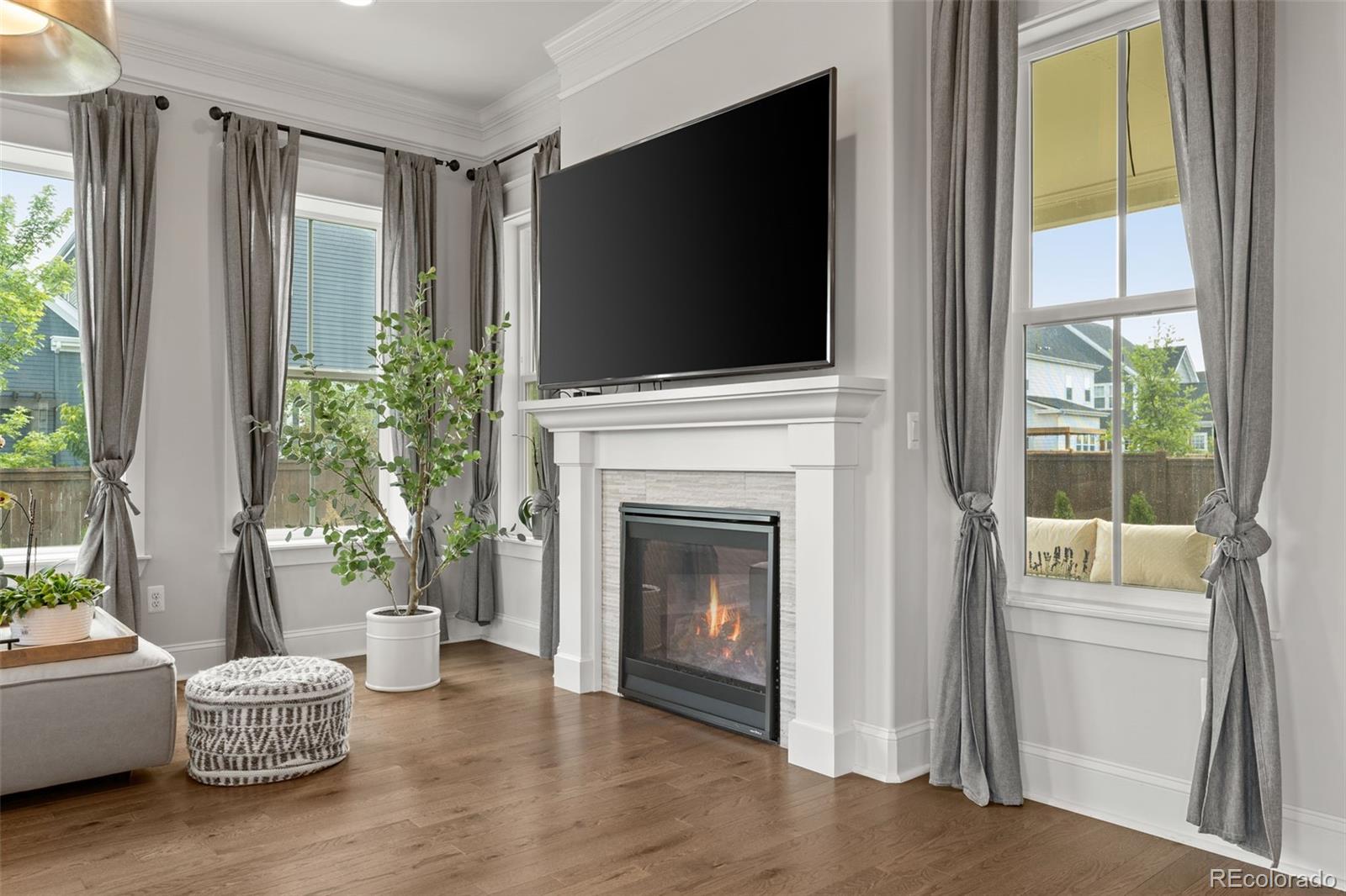 6003 Chester Way Denver, CO 80238 - Photo 13 of 43 a living room with furniture a flat screen tv and a fireplace