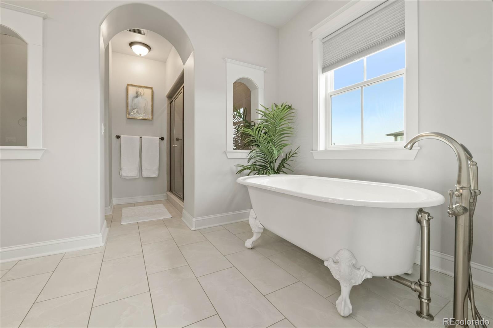 6003 Chester Way Denver, CO 80238 - Photo 19 of 43 a spacious bathroom with a bathtub and shower