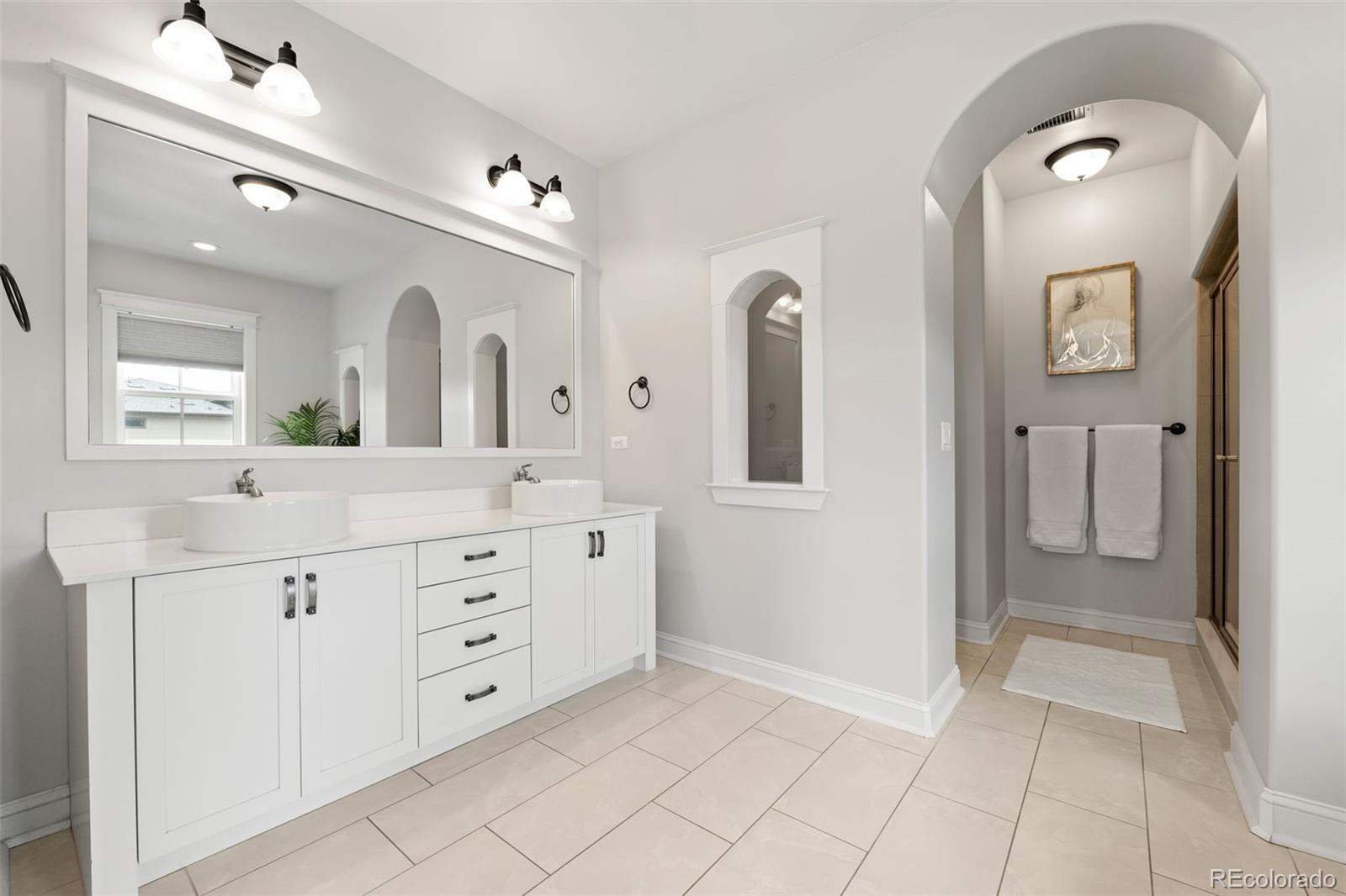 6003 Chester Way Denver, CO 80238 - Photo 20 of 43 a spacious bathroom with a granite countertop sink mirror and a