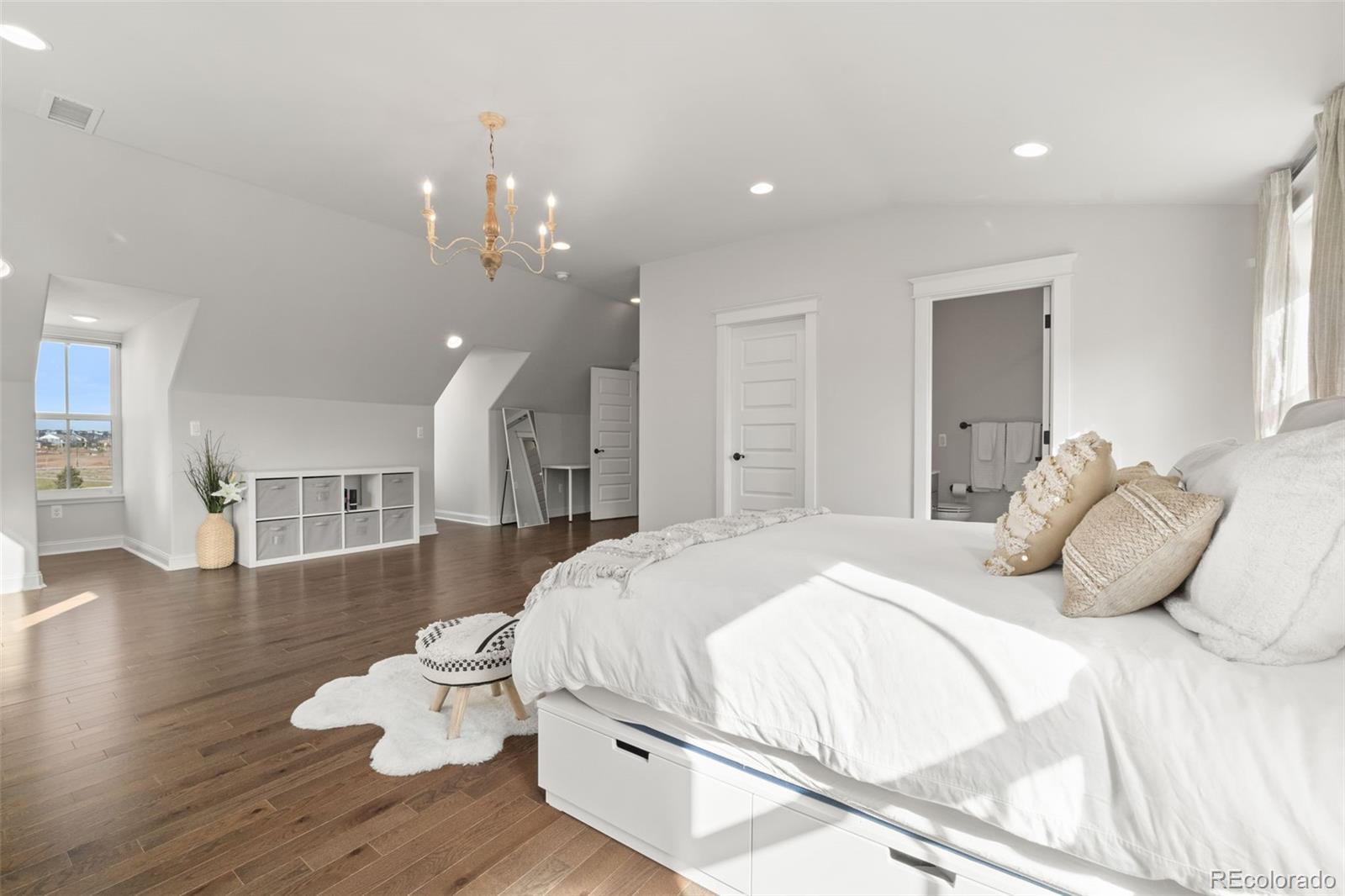 6003 Chester Way Denver, CO 80238 - Photo 23 of 43 a bedroom with a bed and wooden floor