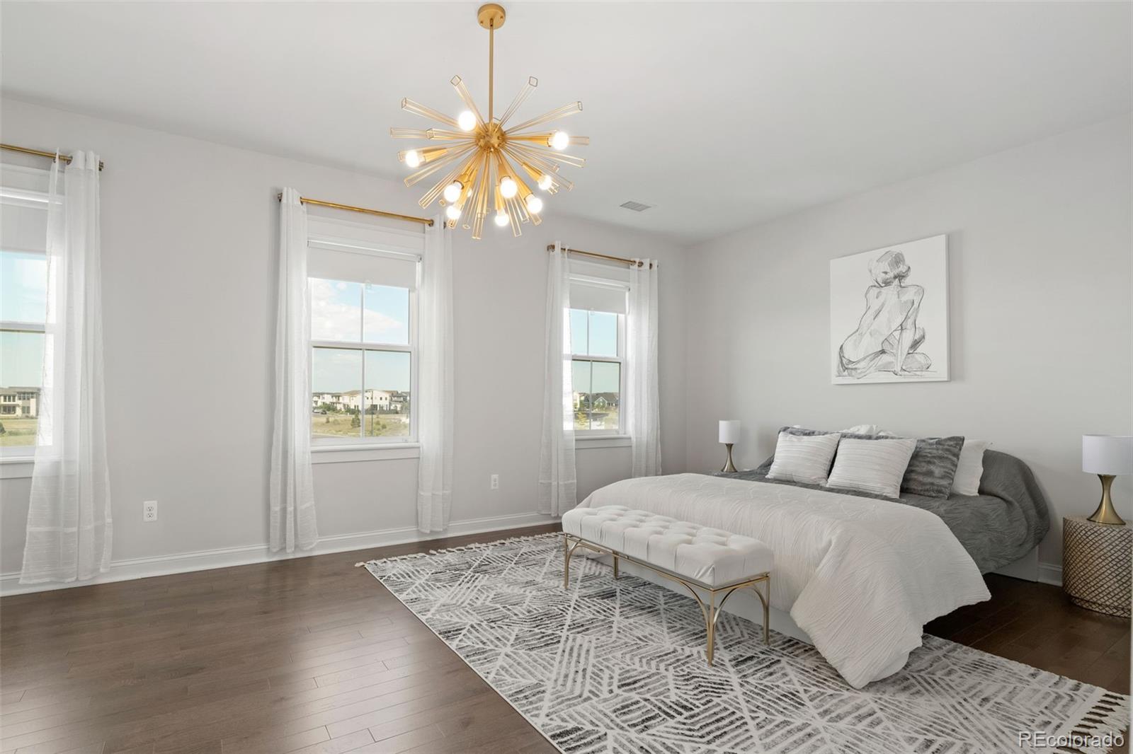 6003 Chester Way Denver, CO 80238 - Photo 25 of 43 a bedroom with a bed and a chandelier