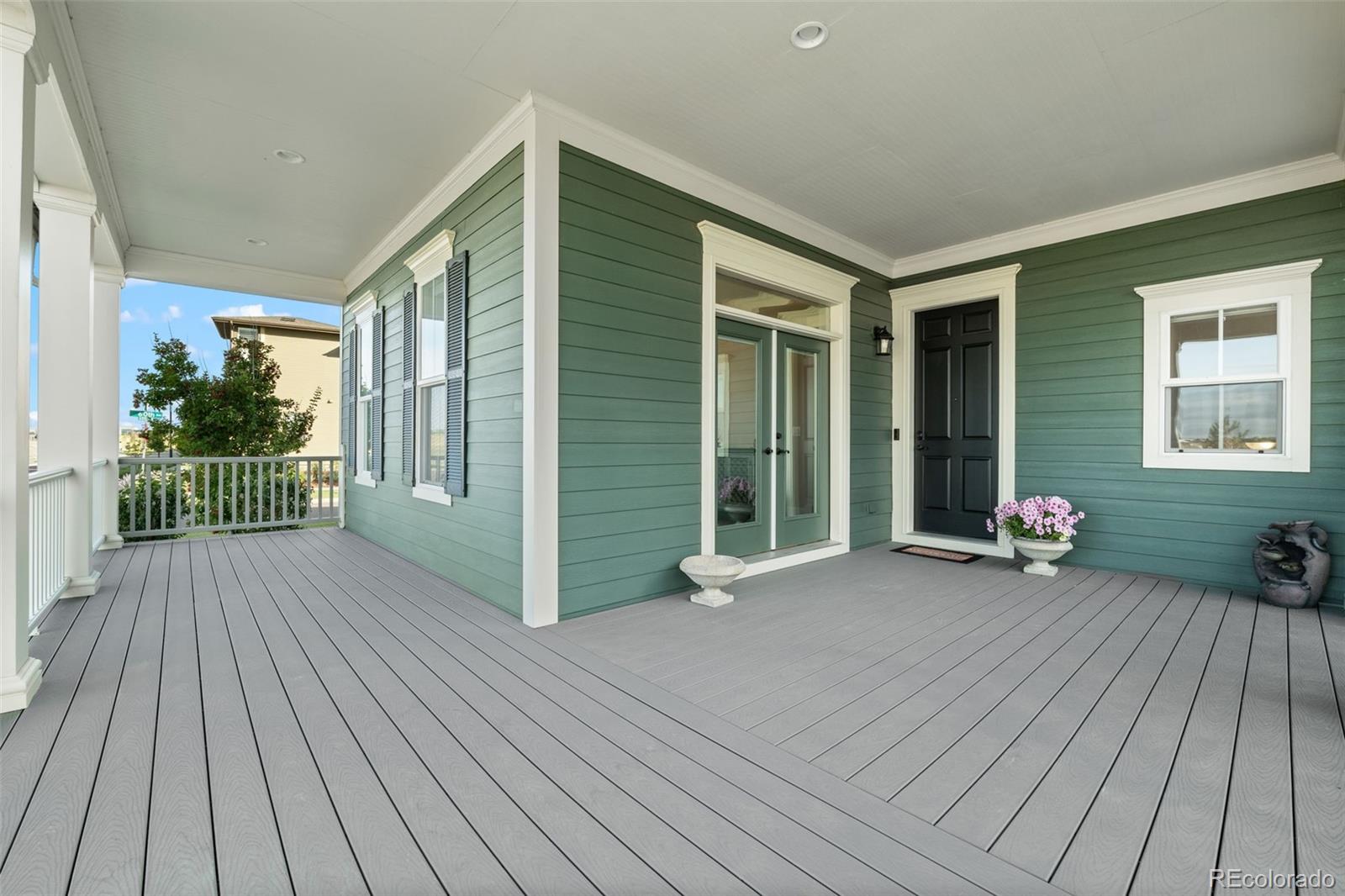 6003 Chester Way Denver, CO 80238 - Photo 42 of 43 a view of a house with wooden floor and bench next to a yard
