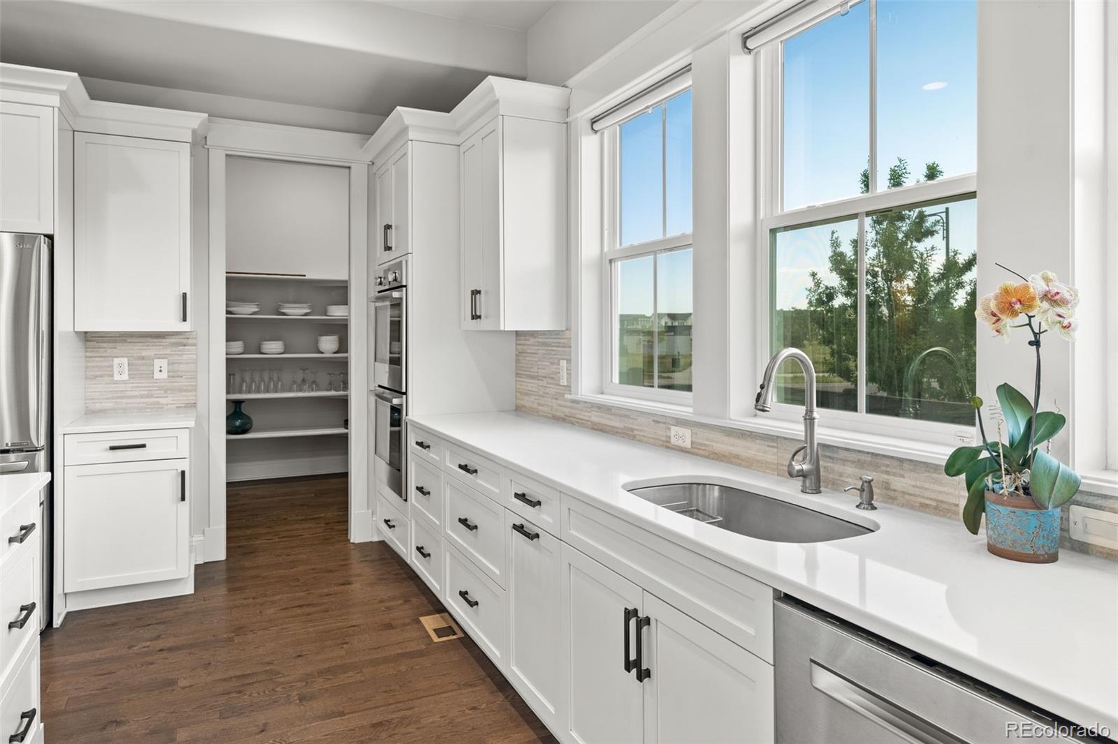 6003 Chester Way Denver, CO 80238 - Photo 10 of 43 a kitchen with granite countertop a sink and a large window