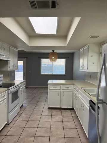 a kitchen with a stove a sink and a refrigerator