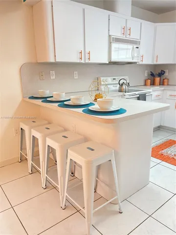 a kitchen with a stove a sink and cabinets