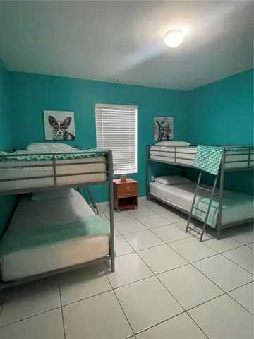 a bedroom with furniture and a window