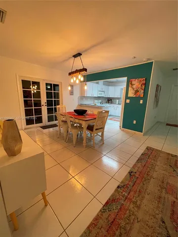 a view of a dining room with furniture and chandelier