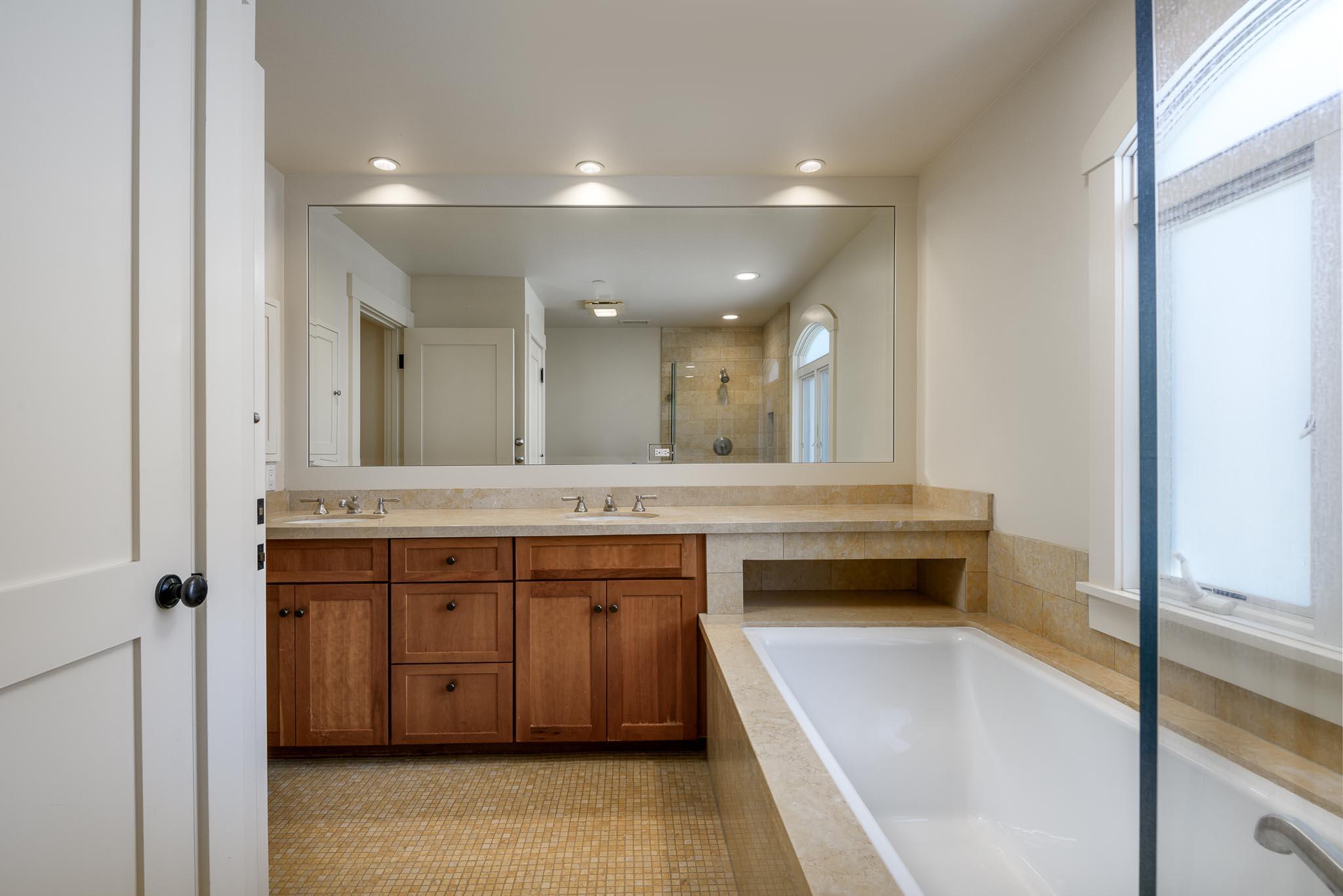 1517 East Valley Road, Unit B Montecito, CA 93108 - Photo 18 of 25 a spacious bathroom with a sink a large mirror and a bathtub