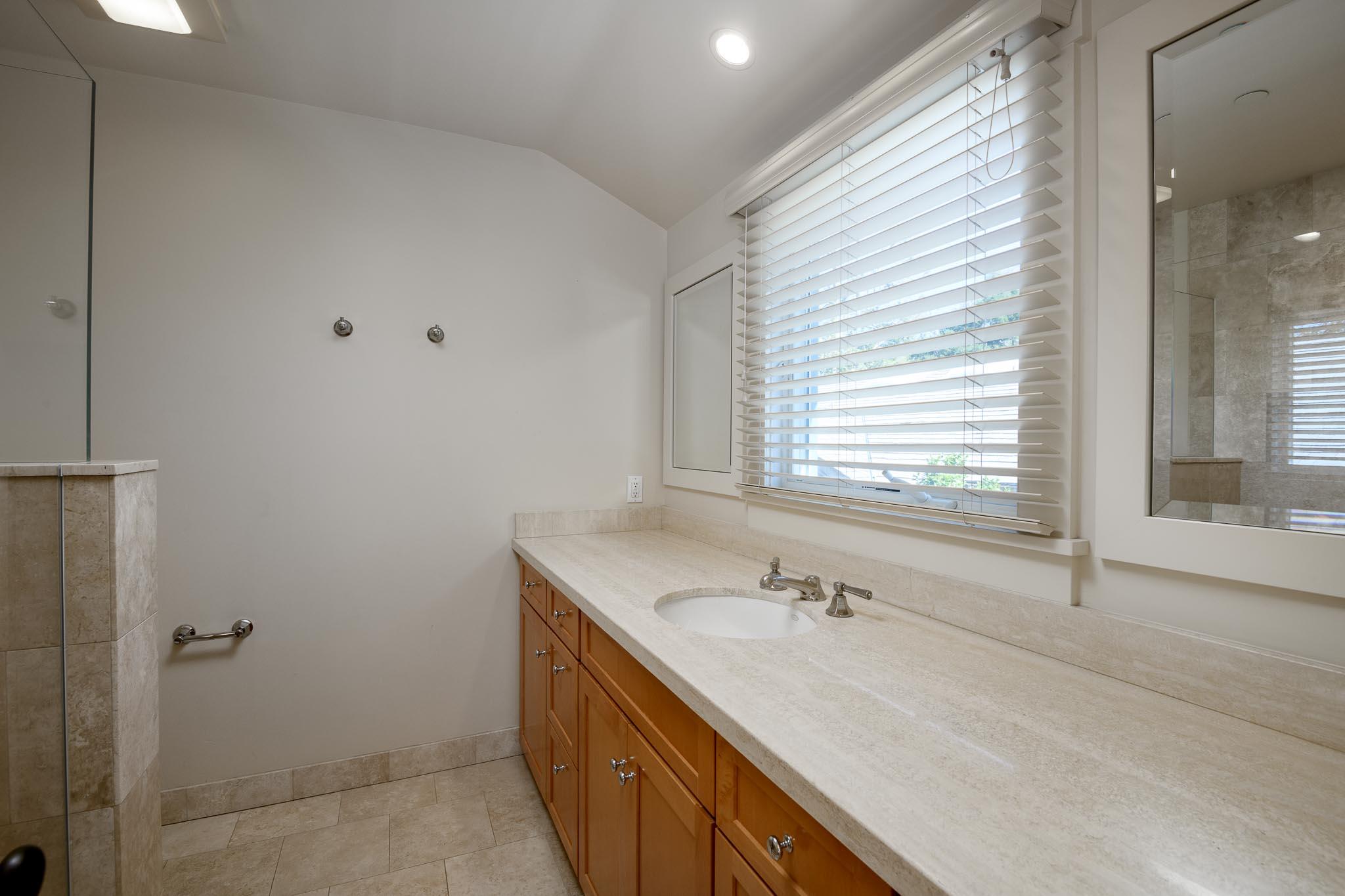 1517 East Valley Road, Unit B Montecito, CA 93108 - Photo 23 of 25 a bathroom with a granite countertop sink and a bathtub