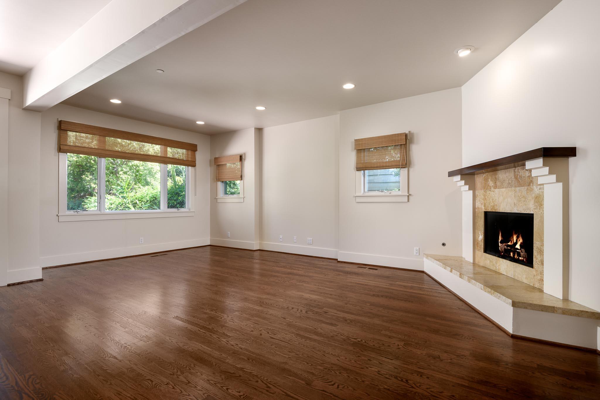 1517 East Valley Road, Unit B Montecito, CA 93108 - Photo 6 of 25 an empty room with wooden floor fireplace and windows