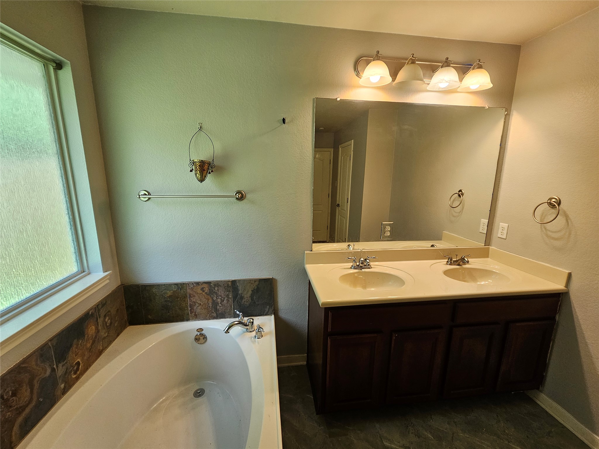 2035 Intrepid Drive Buda, TX 78610 - Photo 15 of 26 Double vanity and soaking tub offer a comfortable, convenient personal retreat.