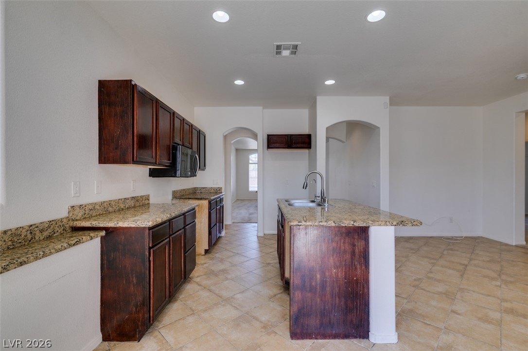 5150 Riverside Run Court North Las Vegas, NV 89081 - Photo 29 of 50 A well-appointed kitchen showcasing elegant granite countertops and modern appliances.
