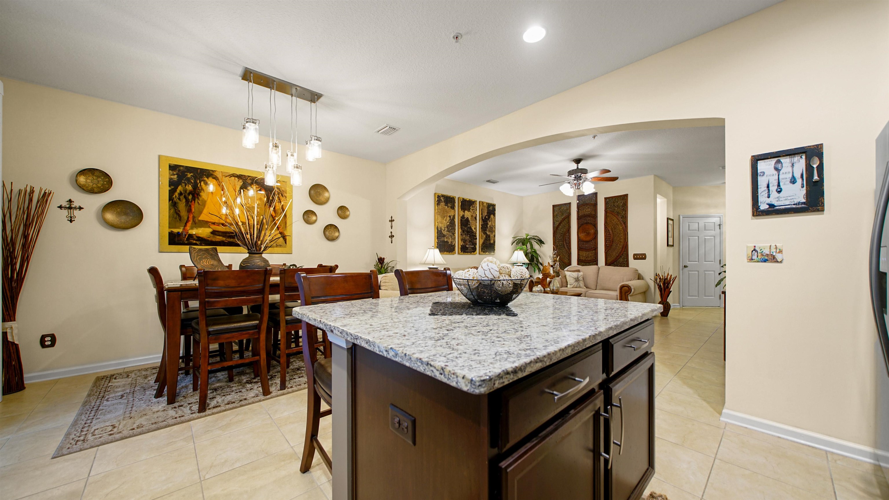 141 San Briso Way St. Augustine, FL 32092 - Photo 12 of 43 a view of kitchen island with granite countertop dining table chairs and refrigerator