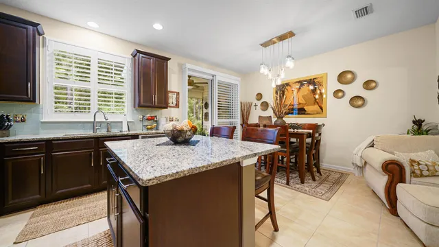 a kitchen with a table chairs sink and cabinets