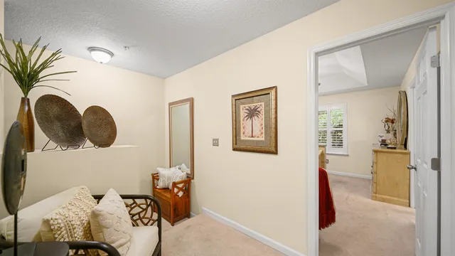 a bedroom with a bed and a potted plant