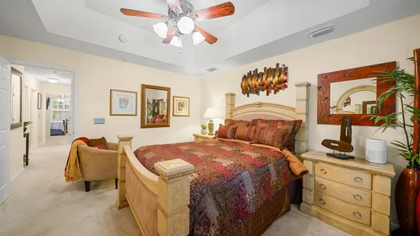 a bedroom with a bed and ceiling fan