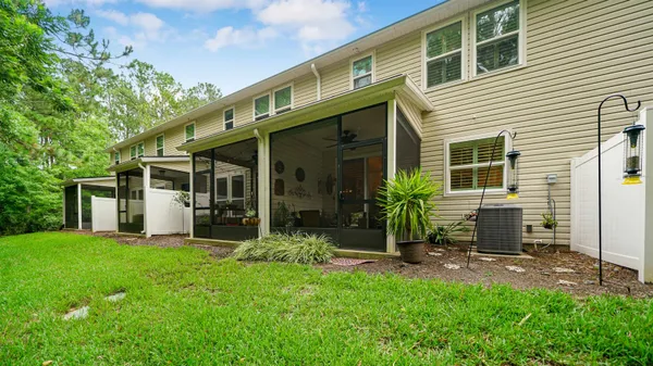 a view of a house with backyard porch and sitting area