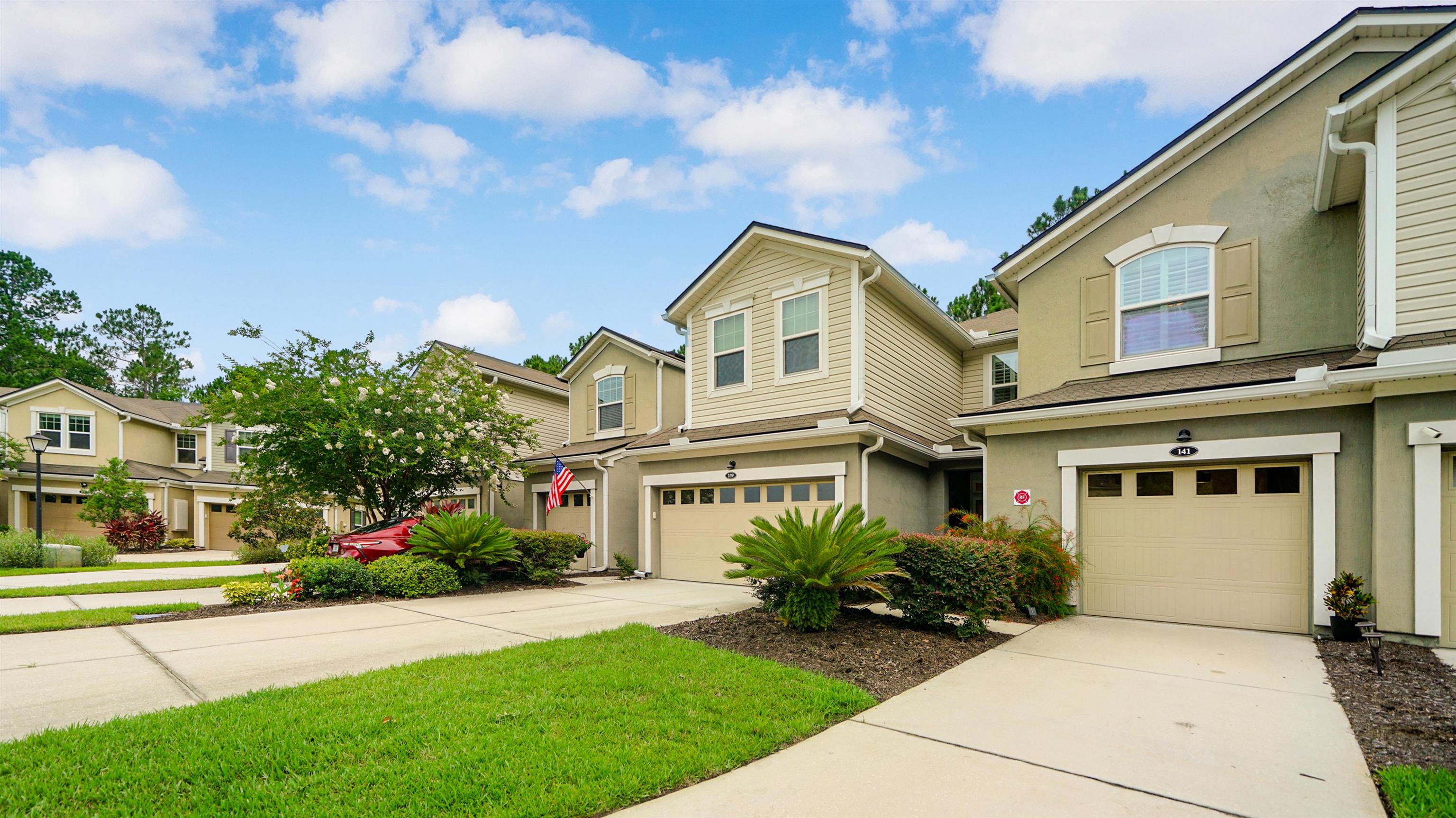 141 San Briso Way St. Augustine, FL 32092 - Photo 40 of 43 a front view of a house with a yard and garage