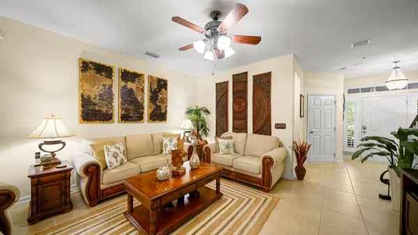 a living room with furniture a chandelier and a window