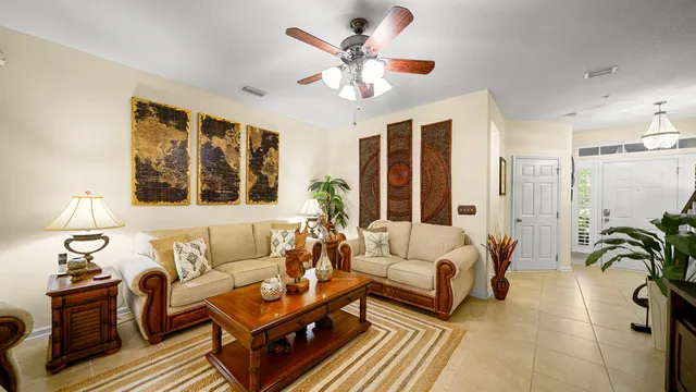 a living room with furniture a chandelier and a window