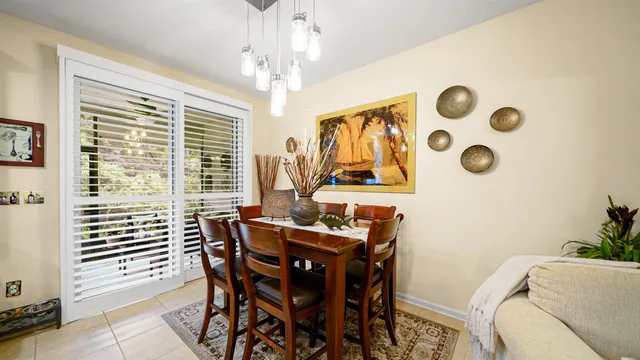 a view of a dining room with furniture and a window