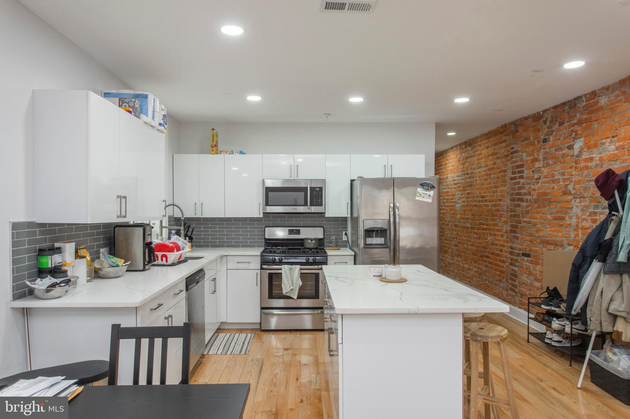1629 Wallace Street, Unit 1R Philadelphia, PA 19130 - Photo 1 of 22 a kitchen with stainless steel appliances a sink stove refrigerator and cabinets