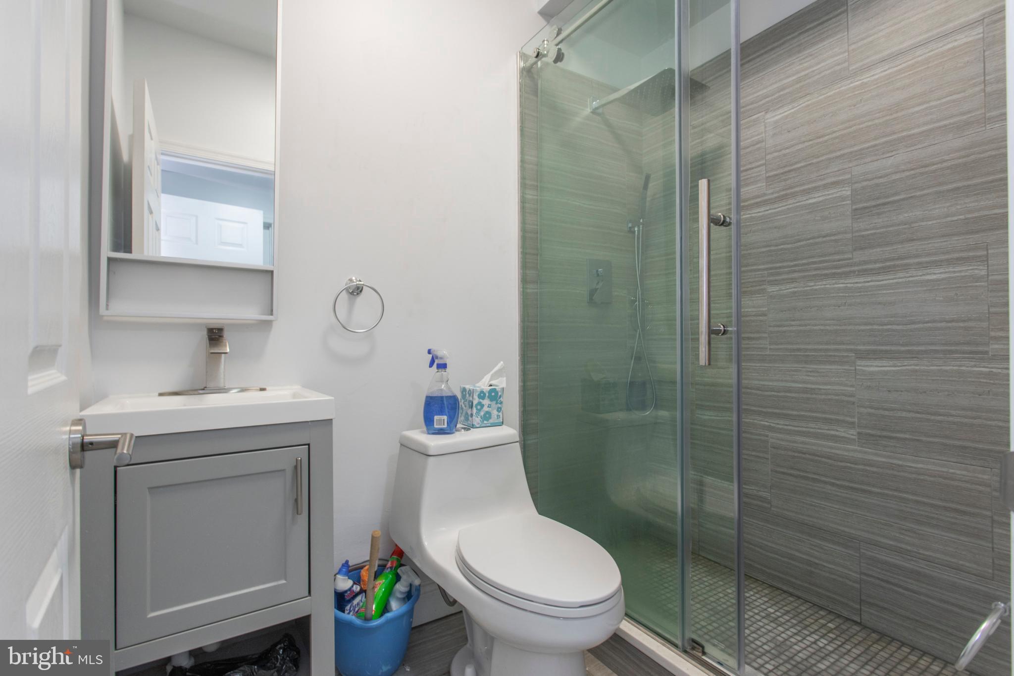 1629 Wallace Street, Unit 1R Philadelphia, PA 19130 - Photo 14 of 22 a bathroom with a toilet sink vanity and shower