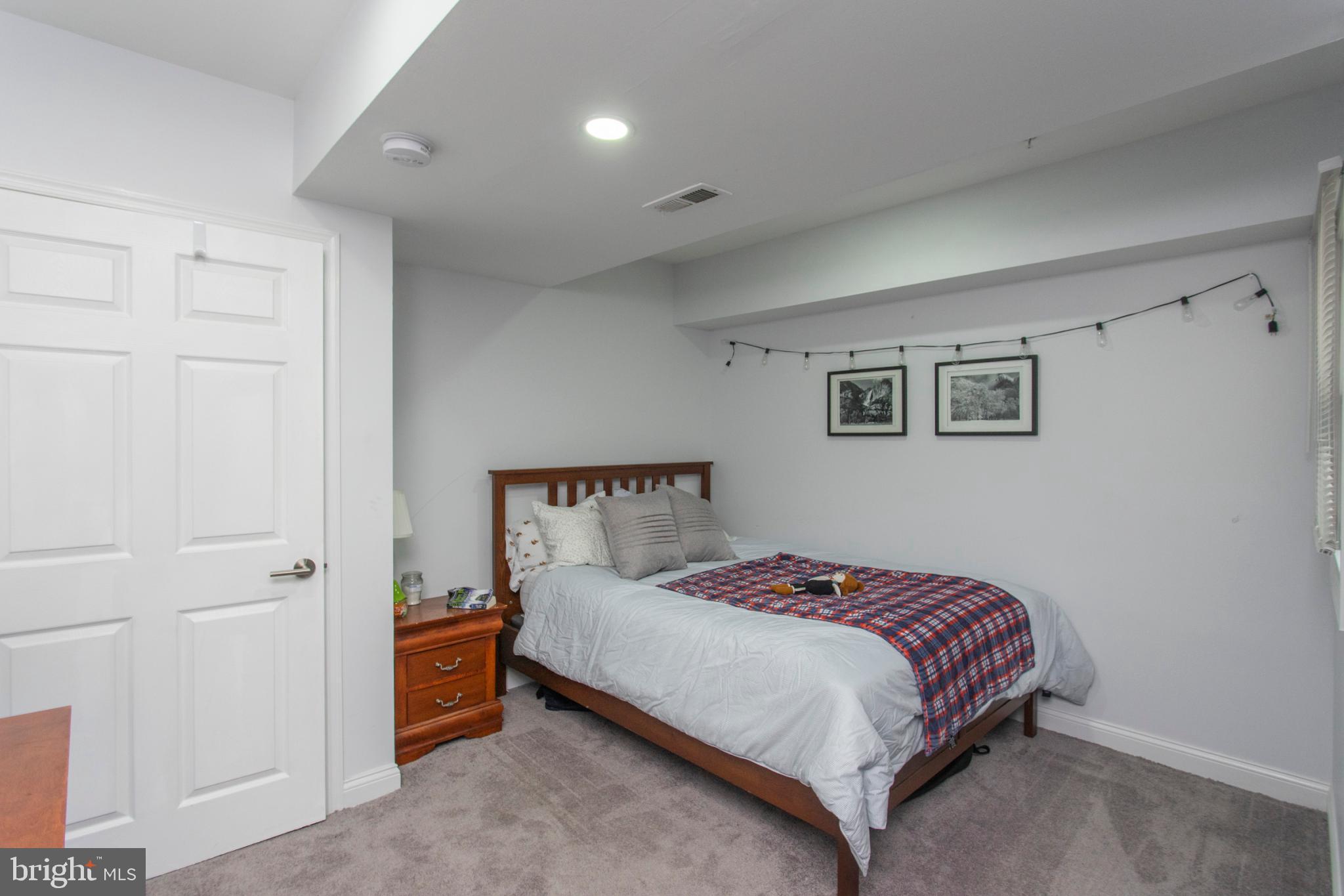 1629 Wallace Street, Unit 1R Philadelphia, PA 19130 - Photo 16 of 22 a bedroom with a bed and a night stand